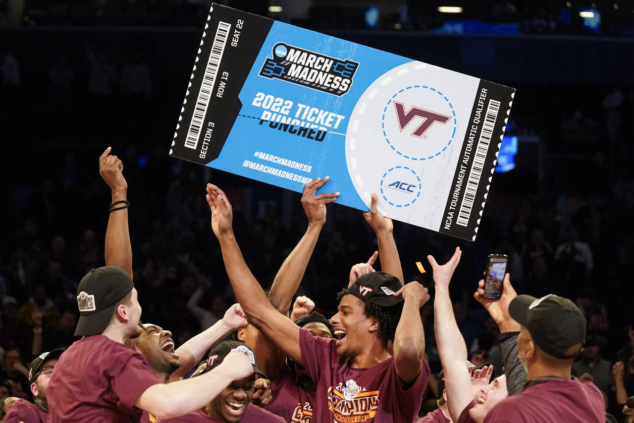 Virginia Tech celebrates after winning the NCAA college basketball championship game against Duke i...
