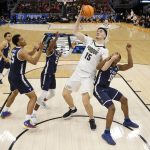 
              Purdue's Zach Edey shoots past Yale's Matthue Cotton during the second half of a first round NCAA college basketball tournament game Friday, March 18, 2022, in Milwaukee. (AP Photo/Jeffrey Phelps)
            
