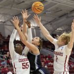 
              Washington State's Bella Murekatete (55) and Tara Wallack (1) battle for a rebound with Kansas State's Ayoka Lee, middle, during the first half of a college basketball game in the first round of the NCAA tournament in Raleigh, N.C., Saturday, March 19, 2022. (AP Photo/Ben McKeown)
            