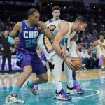 
              Charlotte Hornets forward P.J. Washington (25) reaches in against New Orleans Pelicans center Willy Hernangomez, right, during the first half of an NBA basketball game on Monday, March 21, 2022, in Charlotte, N.C. (AP Photo/Rusty Jones)
            