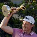 
              Cameron Smith, of Australia, holds the trophy after winning The Players Championship golf tournament Monday, March 14, 2022, in Ponte Vedra Beach, Fla. (AP Photo/Gerald Herbert)
            