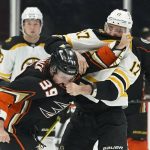 
              Anaheim Ducks center Sam Carrick (39) and Boston Bruins left wing Nick Foligno (17) fight during the first period of an NHL hockey game in Anaheim, Calif., Tuesday, March 1, 2022. (AP Photo/Ashley Landis)
            