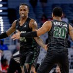 
              Tulane players Kevin Cross (24) and Devon Baker (20) celebrate together in the first half of an NCAA college basketball game against Houston in the semifinals of the American Athletic Conference tournament in Fort Worth, Texas, Saturday, March 12, 2022. (AP Photo/Gareth Patterson)
            