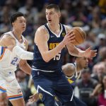 
              Denver Nuggets center Nikola Jokic, right, fields a pass as Oklahoma City Thunder forward Isaiah Roby defends in the first half of an NBA basketball game Saturday, March 26, 2022, in Denver. (AP Photo/David Zalubowski)
            