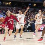 
              Indiana guard Nicole Cardano-Hillary (4) passes around as Maryland guard Katie Benzan (11) defends during an NCAA college basketball game in the Big Ten conference tournament, Friday, March 4, 2022, at Gainbridge Fieldhouse in Indianapolis. (Robert Scheer/The Indianapolis Star via AP)
            