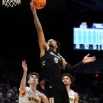 
              Bryant guard Charles Pride (5) shoots past Wright State's Andrew Welage (22) during the first half of a First Four game in the NCAA men's college basketball tournament, Wednesday, March 16, 2022, in Dayton, Ohio. (AP Photo/Jeff Dean)
            