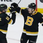 
              Boston Bruins center Trent Frederic (11) is congratulated by Charlie Coyle, right, after his goal against the Los Angeles Kings during the first period of an NHL hockey game, Monday, March 7, 2022, in Boston. (AP Photo/Charles Krupa)
            
