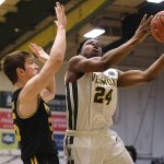 
              Vermont's Ben Shungu goes up to the basket as UMBC's Nathan Johnson, left, defends in the first half of an NCAA college basketball game for the America East Conference tournament championship, Saturday, March 12, 2022, in Burlington, Vt. (AP Photo/Jessica Hill)
            