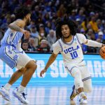 
              UCLA's Tyger Campbell (10) tries to get past North Carolina's R.J. Davis (4) during the first half of a college basketball game in the Sweet 16 round of the NCAA tournament, Friday, March 25, 2022, in Philadelphia. (AP Photo/Matt Rourke)
            
