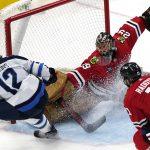
              Chicago Blackhawks goaltender Marc-Andre Fleury (29) cannot make the save on a goal by Winnipeg Jets center Jansen Harkins (12) during the second period of an NHL hockey game in Chicago, Sunday, March 20, 2022. (AP Photo/Nam Y. Huh)
            