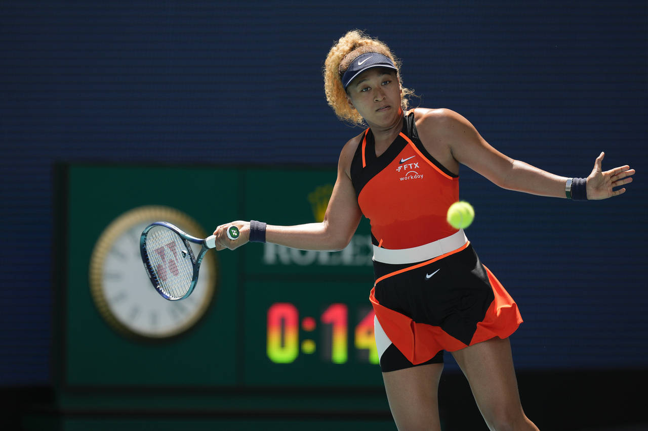 Naomi Osaka of Japan returns a ball against Astra Sharma of Australia in their first round women's ...
