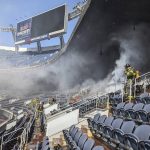 
              In this photo provided by the Denver Fire Department, firefighters battle a fire at Empower Field at Mile High stadium in Denver, Thursday, March 24, 2022. Firefighters have extinguished a blaze that torched several rows of seats and a suite area at the Denver Broncos' stadium. The fire broke out in the third-level and burned at least six rows of seats in two sections. (Denver Fire Department via AP)
            