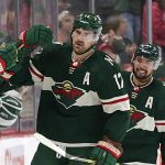 
              Minnesota Wild left wing Marcus Foligno (17) and Matt Dumba (24) celebrate with teammates after Foligno's goal against the New York Rangers during the second period of an NHL hockey game Tuesday, March 8, 2022, in St. Paul, Minn. (AP Photo/Andy Clayton-King)
            