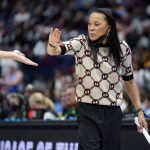 
              South Carolina head coach Dawn Staley congratulates a player during the second half of an NCAA college basketball semifinal round game against Mississippi at the women's Southeastern Conference tournament Saturday, March 5, 2022, in Nashville, Tenn. South Carolina won 61-51. (AP Photo/Mark Humphrey)
            