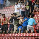 
              Fans clash during a Mexican soccer league match between the host Queretaro and Atlas from Guadalajara, at the Corregidora stadium, in Queretaro, Mexico, Saturday, March 5, 2022. Multiple people were injured in the brawl, including two critically. (AP Photo/Sergio Gonzalez)
            