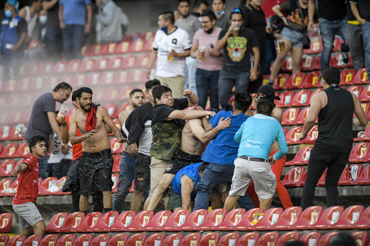 Fans clash during a Mexican soccer league match between the host Queretaro and Atlas from Guadalaja...
