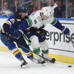 
              Vancouver Canucks' Alex Chiasson (39) fights for the puck against St. Louis Blues' Mackenzie MacEachern (28) during the second period of an NHL hockey game Monday, March 28, 2022 in St. Louis. (AP Photo/Michael Thomas)
            