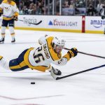 Nashville Predators forward Philip Tomasino goes to the ice after missing on a shot during the third period of the team's NHL hockey game against the Seattle Kraken, Wednesday, March 2, 2022, in Seattle. The Kraken won 4-3. (AP Photo/Stephen Brashear)
