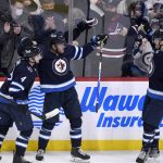 
              Winnipeg Jets' Andrew Copp celebrates his goal against the Montreal Canadiens with teammates Neal Poink (4) and Adam Lowry (17) during the second period of an NHL hockey game Tuesday, March 1, 2022, in Winnipeg, Manitoba. (Fred Greenslade/The Canadian Press via AP)
            