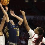 
              Notre Dame guard Sonia Citron (11) fights Oklahoma guard Skylar Vann (24) and Liz Scott, right, in the first half of a second-round game in the NCAA women's college basketball tournament Monday, March 21, 2022, in Norman, Okla. (AP Photo/ Mitch Alcala)
            