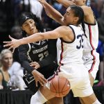 
              Georgetown's Milan Bolden-Morris (23) passes around Connecticut's Azzi Fudd (35) and Olivia Nelson-Ododa in the first half of an NCAA college basketball game in the Big East tournament quarterfinals at Mohegan Sun Arena, Saturday, March 5, 2022, in Uncasville, Conn. (AP Photo/Jessica Hill)
            