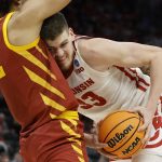 
              Wisconsin's Chris Vogt runs into Iowa State's Robert Jones during the first half of a second-round NCAA college basketball tournament game Sunday, March 20, 2022, in Milwaukee. (AP Photo/Jeffrey Phelps)
            