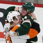 
              Minnesota Wild left wing Nicolas Deslauriers (44) and Philadelphia Flyers defenseman Nick Seeler (24) fight in the first period of an NHL hockey game Tuesday, March 29, 2022, in St. Paul, Minn. (AP Photo/Andy Clayton-King)
            