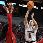 
              Louisville guard Mykasa Robinson (5) shoots over Gonzaga forward Melody Kempton (33) during the second half of a women's NCAA tournament college basketball second-round game in Louisville, Ky., Sunday, March 20, 2022. Louisville won 68-59. (AP Photo/Timothy D. Easley)
            