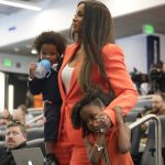 
              Ciara Wilson, center, wife of Denver Broncos new starting quarterback Russell Wilson, leads in tow of the couple's children, Win, left, and Sienna, to a news conference Wednesday, March 16, 2022, at the team's headquarters in Englewood, Colo. (AP Photo/David Zalubowski)
            