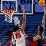 
              Tulane guard Devon Baker (20) releases a shot over Houston forward Josh Carlton (25) in the first half of an NCAA college basketball game in the semifinals of the American Athletic Conference tournament in Fort Worth, Texas, Saturday, March 12, 2022. (AP Photo/Gareth Patterson)
            