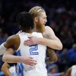 
              North Carolina's Brady Manek, right, and Caleb Love embrace during the second half of a college basketball game against St. Peter's in the Elite 8 round of the NCAA tournament, Sunday, March 27, 2022, in Philadelphia. (AP Photo/Matt Rourke)
            