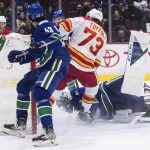 
              Vancouver Canucks goalie Thatcher Demko, right, stops Calgary Flames' Tyler Toffoli (73) during the second period of an NHL hockey game Saturday, March 19, 2022, in Vancouver, British Columbia. (Darryl Dyck/The Canadian Press via AP)
            