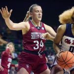 
              South Dakota center Hannah Sjerven (34) defends as Mississippi forward Shakira Austin (0) looks to pass during the first half of a college basketball game in the first round of the NCAA tournament in Waco, Texas, Friday, March 18, 2022. (AP Photo/LM Otero)
            