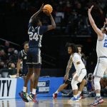 
              Akron forward Ali Ali, left, shoots over UCLA guard Jaime Jaquez Jr., right, during the first half of a first-round NCAA college basketball tournament game, Thursday, March 17, 2022, in Portland, Ore. (AP Photo/Craig Mitchelldyer)
            