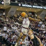 
              Texas A&M's Quenton Jackson (3) flies through the air for a dunk over Wake Forest's Cameron Hildreth during the first half of an NCAA college basketball game in the third round of the NIT in College Station, Texas, Wednesday, March 23, 2022. (Michael Miller/College Station Eagle via AP)
            