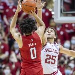 
              Indiana forward Race Thompson (25) attempts to block a shot by Rutgers guard Geo Baker (0) during the second half of an NCAA college basketball game, Wednesday, March 2, 2022, in Bloomington, Ind. (AP Photo/Doug McSchooler)
            