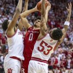 
              Rutgers guard Geo Baker (0) attempts a shot while being defended by Indiana center Michael Durr, left, and guard Tamar Bates (53) during the first half of an NCAA college basketball game, Wednesday, March 2, 2022, in Bloomington, Ind. (AP Photo/Doug McSchooler)
            