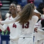 
              Arkansas' Erynn Barnum (4) and Sasha Goforth (13) celebrate their overtime win against Missouri in an NCAA college basketball game at the women's Southeastern Conference tournament Thursday, March 3, 2022, in Nashville, Tenn. (AP Photo/Mark Humphrey)
            