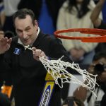 
              Duke head coach Mike Krzyzewski celebrates while cutting down the net after Duke defeated Arkansas in a college basketball game in the Elite 8 round of the NCAA men's tournament in San Francisco, Saturday, March 26, 2022. (AP Photo/Tony Avelar)
            