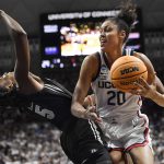 
              Connecticut's Olivia Nelson-Ododa, right, fouls Central Florida's Masseny Kaba during the second half of a second-round women's college basketball game in the NCAA tournament, Monday, March 21, 2022, in Storrs, Conn. (AP Photo/Jessica Hill)
            