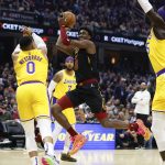 
              Cleveland Cavaliers' Caris LeVert (3) shoots against Los Angeles Lakers' Russell Westbrook (0) and Wenyen Gabriel (35) during the first half of an NBA basketball game, Monday, March 21, 2022, in Cleveland. (AP Photo/Ron Schwane)
            