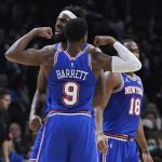 
              New York Knicks center Mitchell Robinson, center, celebrates his basket with RJ Barrett (9) during the second half of an NBA basketball game against the Los Angeles Clippers Sunday, March 6, 2022, in Los Angeles. (AP Photo/Marcio Jose Sanchez)
            