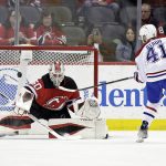 
              New Jersey Devils goaltender Nico Daws makes a save on a shot by Montreal Canadiens left wing Paul Byron (41) during the a shootout in an NHL hockey game Sunday, March 27, 2022, in Newark, N.J. (AP Photo/Adam Hunger)
            