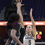 
              Connecticut's Paige Bueckers, right, shoots over Georgetown's Ariel Jenkins during the first half of an NCAA college basketball game in the quarterfinals of the Big East Conference tournament at Mohegan Sun Arena, Saturday, March 5, 2022, in Uncasville, Conn. (AP Photo/Jessica Hill)
            