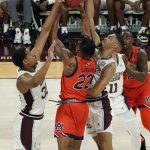 
              Mississippi State forwards Garrison Brooks (10) and Tolu Smith (35) attempt to block a layup attempt by Auburn guard Allen Flanigan (22) during the first half of an NCAA college basketball game in Starkville, Miss., Wednesday, March. 2, 2022. (AP Photo/Rogelio V. Solis)
            