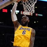 
              Los Angeles Lakers forward LeBron James (6) dunks during the first half of an NBA basketball game against the Golden State Warriors in Los Angeles, Saturday, March 5, 2022. (AP Photo/Ashley Landis)
            