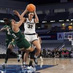 
              South Florida guard Sydni Harvey (3) takes a charge on a shot attempt by Central Florida forward Brittney Smith (32) in the first half of an NCAA college basketball game for the American Athletic Conference women's tournament championship Thursday, March 10, 2022, in Fort Worth, Texas. (AP Photo/Tony Gutierrez)
            