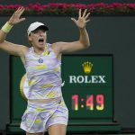 
              Iga Swiatek, of Poland, reacts after defeating Simona Halep, of Romania, in their women's singles semifinals match at the BNP Paribas Open tennis tournament Friday, March 18, 2022, in Indian Wells, Calif. (AP Photo/Mark J. Terrill)
            