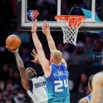 
              Dallas Mavericks forward Dorian Finney-Smith, left, is defended by Charlotte Hornets center Mason Plumlee (24) during the first half of an NBA basketball game Saturday, March 19, 2022, in Charlotte, N.C. (AP Photo/Rusty Jones)
            