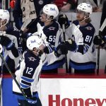 
              Winnipeg Jets center Jansen Harkins (12) celebrates with teammates after he scored a goal during the second period of an NHL hockey game against the Chicago Blackhawks in Chicago, Sunday, March 20, 2022. (AP Photo/Nam Y. Huh)
            